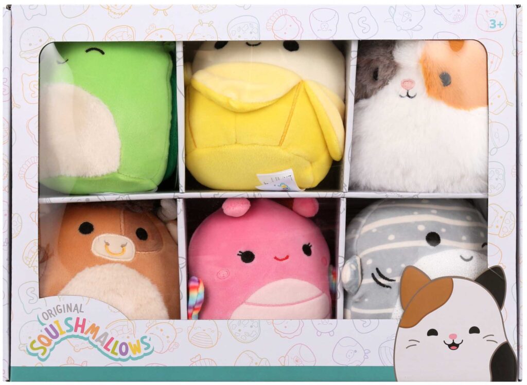 Boxed set of six colorful Squishmallows plush toys including frog, banana, cat, bear, pink creature, and dolphin.