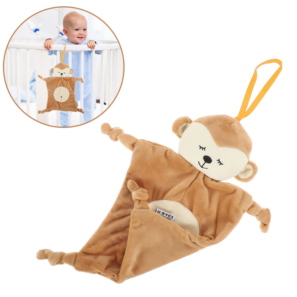 Soft brown monkey plush hanging toy with a pouch and loop, shown near a baby crib with a smiling baby looking on.
