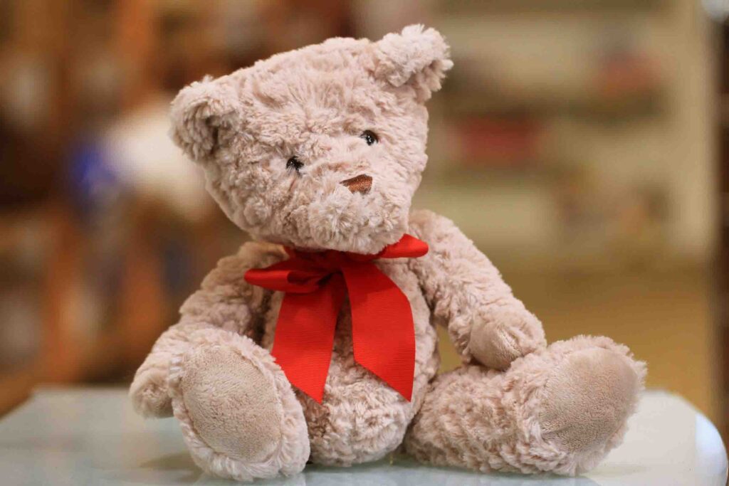 Plush teddy bear with red ribbon