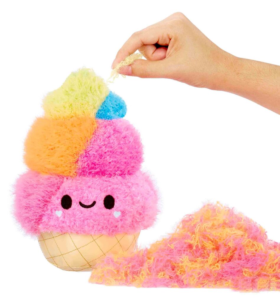 Hand pulling colorful soft plush stuffing from toy