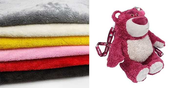 Stack of colorful plush fabrics next to a purple and white plush bear toy