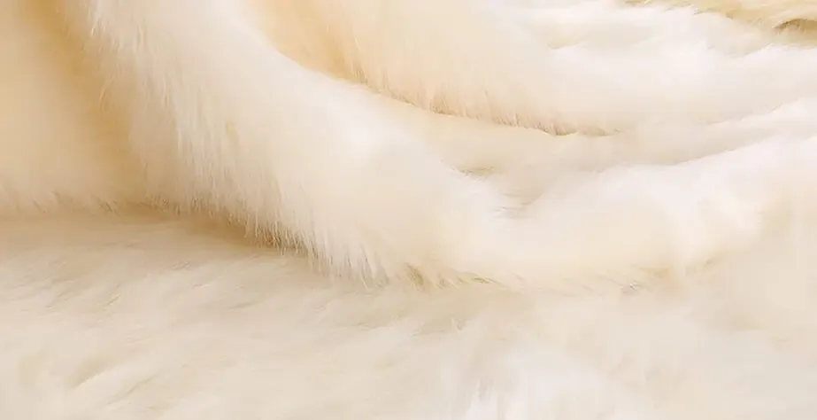 Soft white faux fur fabric texture.