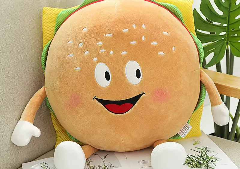 Cute smiling burger plush pillow with arms and legs