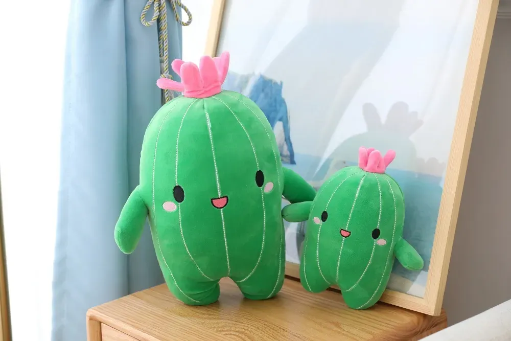 Green cactus plush toys with pink flowers and smiling faces