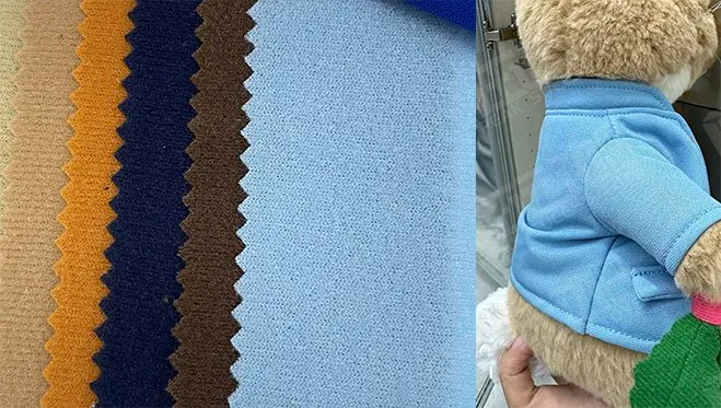 Various colored velour fabric swatches next to a plush toy wearing a blue velour jacket.