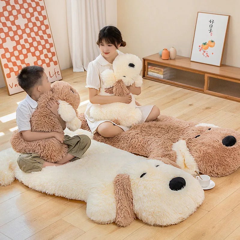 Child and woman sitting on large plush dog-shaped floor pillows while hugging matching stuffed dogs in a cozy room.