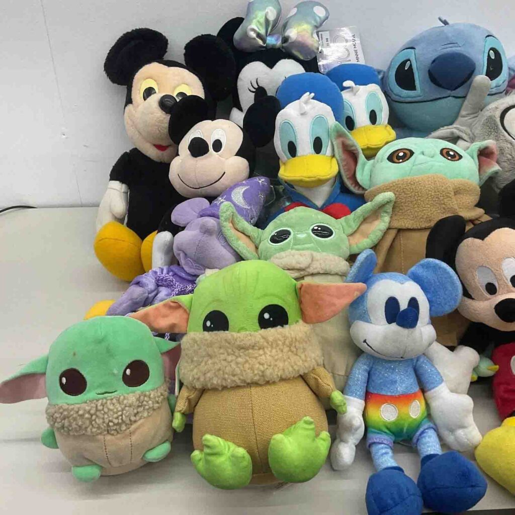 Assorted plush toys and dolls group on table