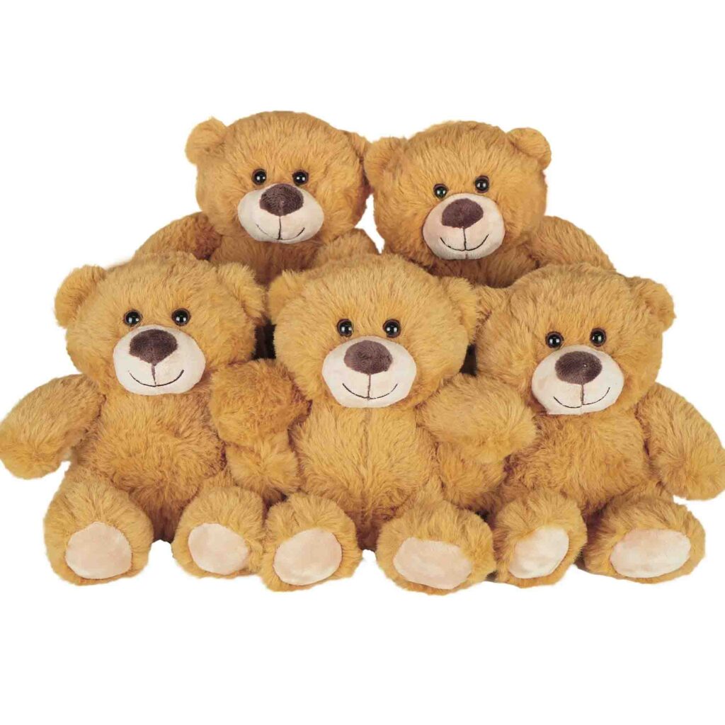 Group of five identical brown teddy bears with smiling faces sitting together.
