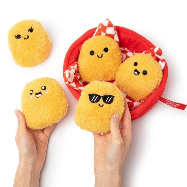 Cute plush nuggets with faces in red basket