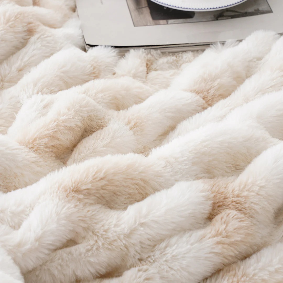 Cream-colored soft plush fabric with a fluffy texture