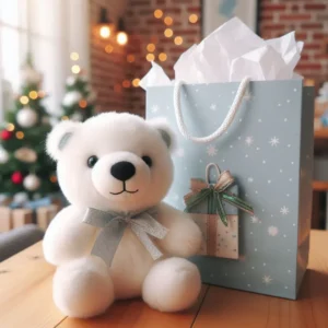 White plush bear with silver bow next to blue gift bag.