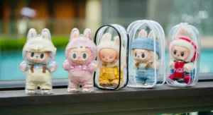 Labubu plush dolls in clear plastic cases.