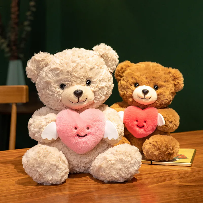 Two teddy bears holding pink and red heart plushies.