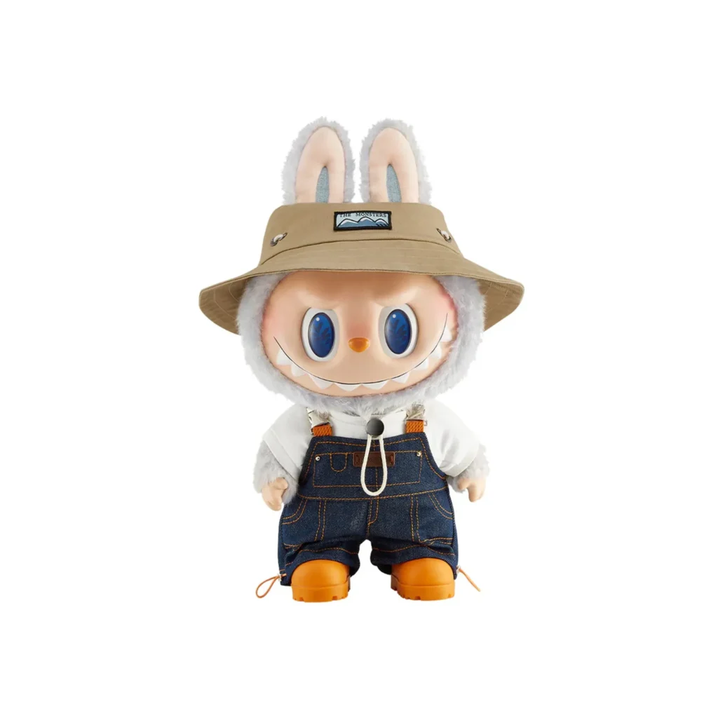 Labubu doll in denim overalls and bucket hat with bunny ears.
