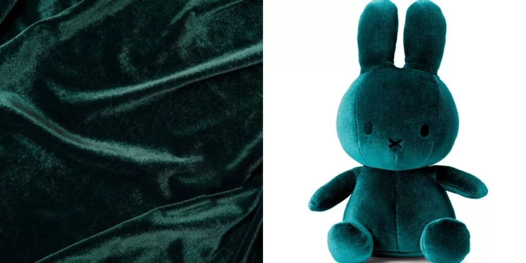 Dark green velvet fabric and plush bunny toy with long ears.