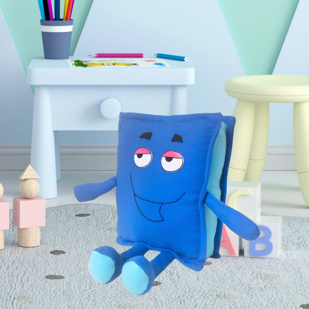 Blue plush toy with cartoon face sitting on carpet near kids’ table and blocks.