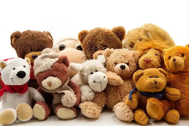 Group of various soft and cuddly stuffed animals sitting together.