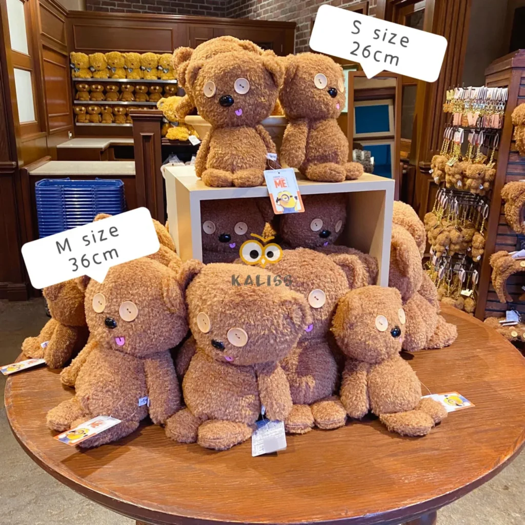 Brown teddy bear with button eyes and sticking tongue.
