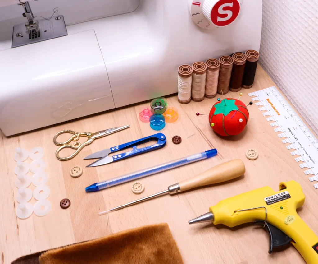 Sewing machine and various plush toy crafting tools on wooden table