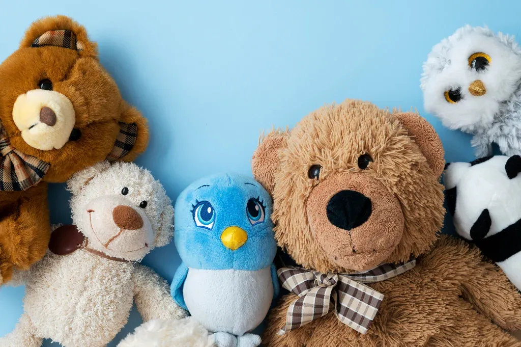 Assorted plush toys on blue background