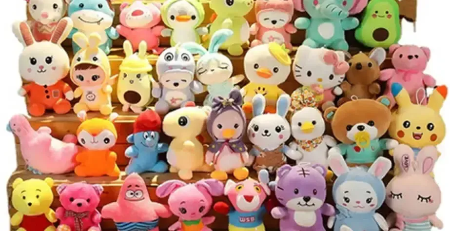 Colorful plush toys arranged on wooden shelves in various animal and character shapes.