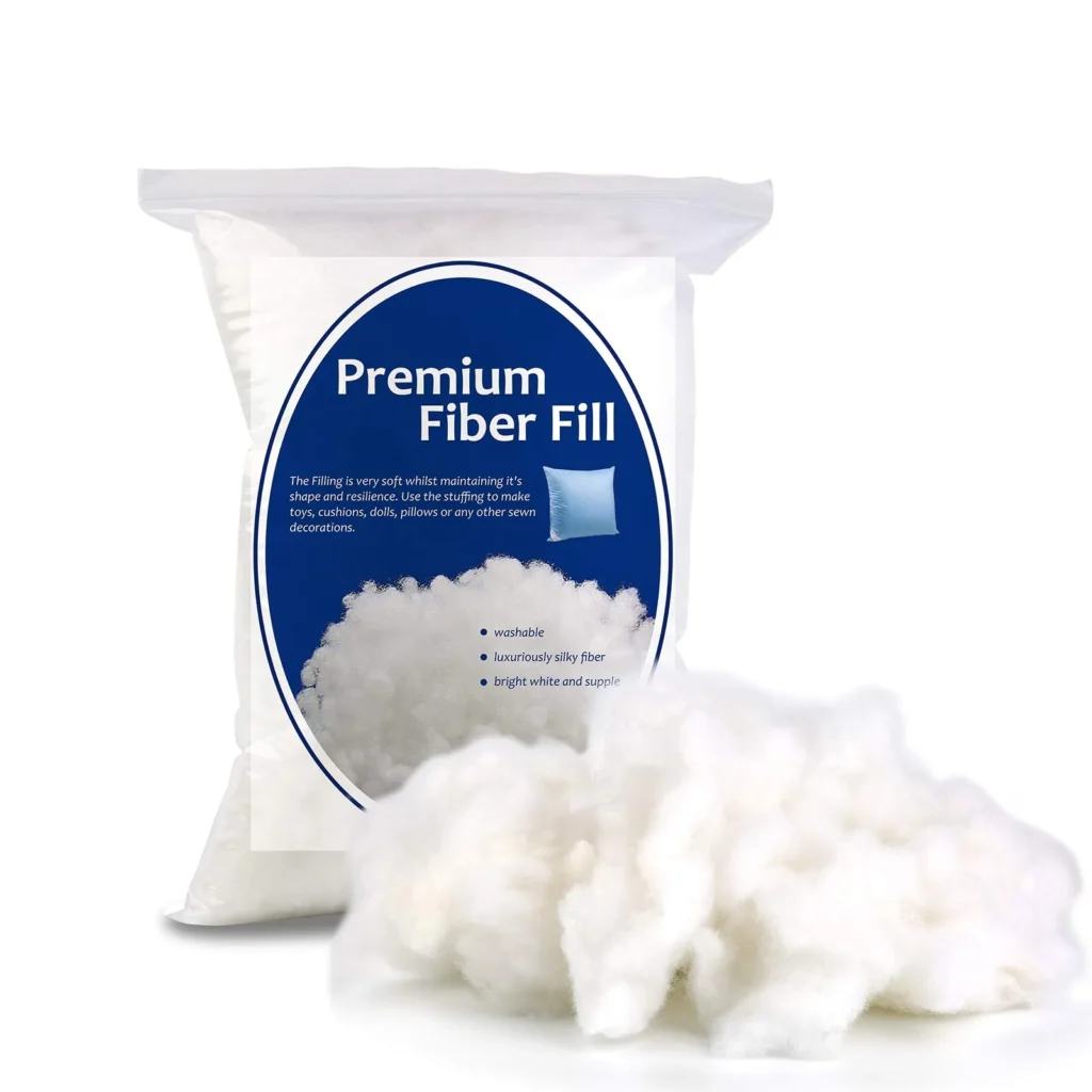 Bag of premium fiber fill stuffing with loose fiber spilling out on white background.