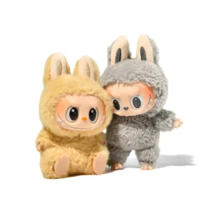 Two small dolls in fuzzy bunny costumes, one yellow and one gray, on white background.