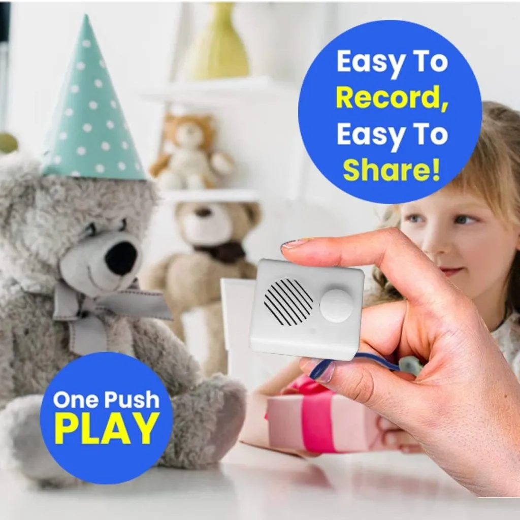 Hand holding small voice recorder near teddy bear with child in background.