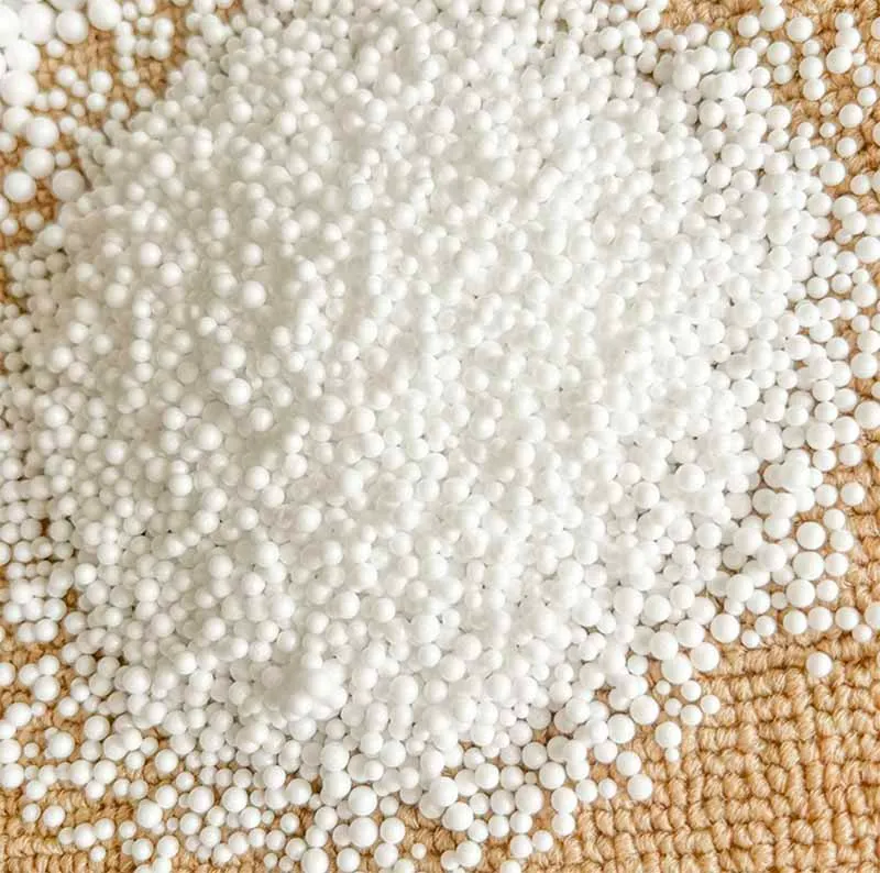 White foam beads for plush toy stuffing on woven surface
