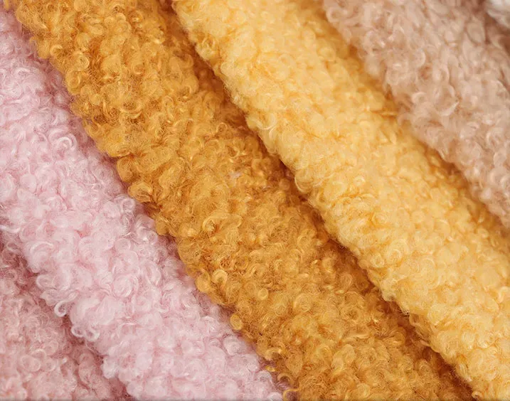 Close-up of colorful soft sherpa fleece fabric textures in warm tones.