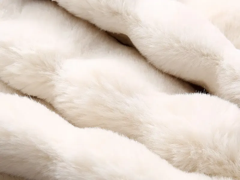 Close-up of soft white plush fabric texture.