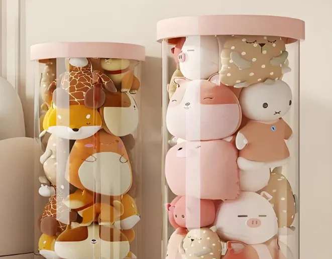 Clear cylindrical containers filled with various stacked plush toys in pastel colors