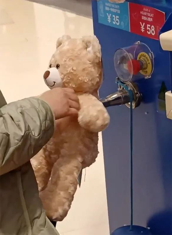 Hand stuffing plush teddy bear with machine control