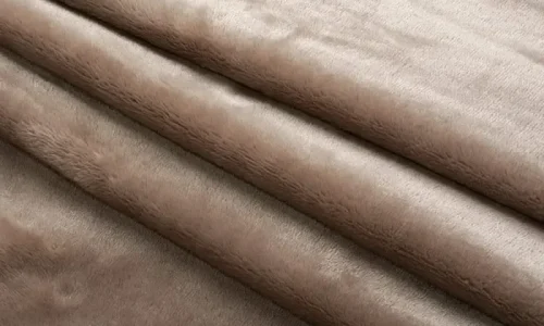 Short Plush Fabric Soft brown short plush fabric rolls stacked neatly.